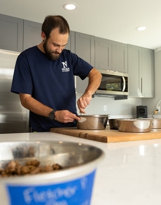 Trainer preparing dog food bowls in the academy kitchen